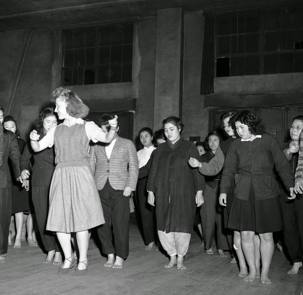 Barbara McBride teaches Russian-style Korobotchka dance to her Japanese students in Tokyo at the YWCA, once a week as seen here, Dec. 29, 1946. 