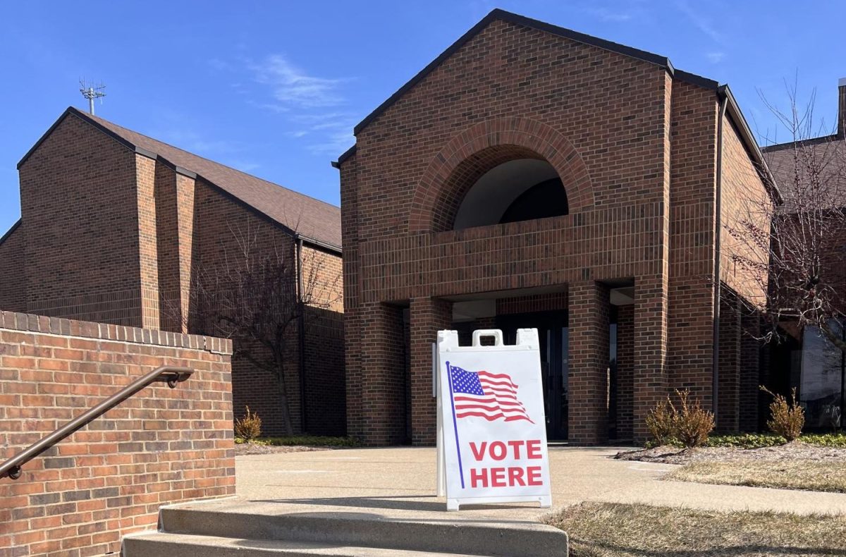 Approaching a polling place, a vote here sign welcomes voters to a Grand Rapids voting site